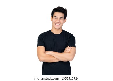 Smiling handsome Asian man in casual black t-shirt with arm crossed looking at camera studio shot isolated on white background