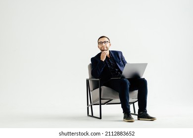 Smiling handsome businessman working with laptop. Isolated over white background - Shutterstock ID 2112883652