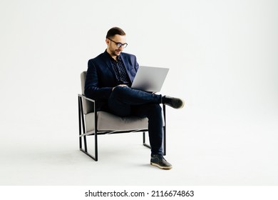 Smiling handsome businessman working with laptop. Isolated over white background - Shutterstock ID 2116674863