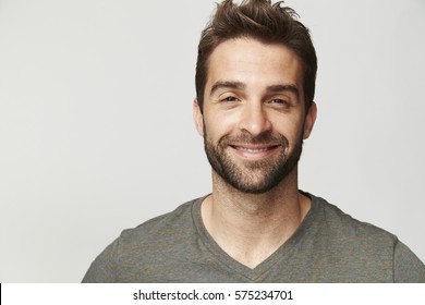 Smiling handsome dude in grey, portrait - Shutterstock ID 575234701