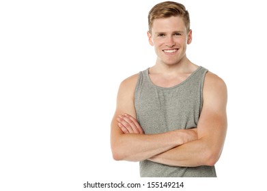 Smiling handsome man posing with folded arms