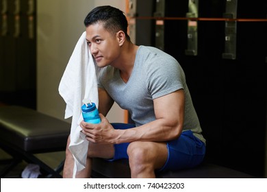 Smiling handsome Vietnamese athlete wiping sweat off his forehead - Powered by Shutterstock