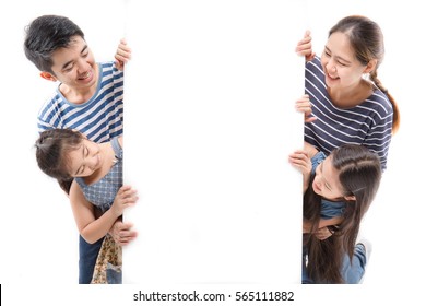 Smiling Happy Asian Family With Big White Poster On Isolated Background