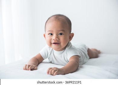 Smiling Happy Baby Tummy Time On Bed