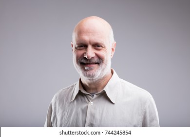 Smiling Happy Bald Old Man Portrait On A Neutral Gray Background