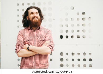 Smiling Happy Bearded Hipster Man With Crossed Arms Looking Away Outside