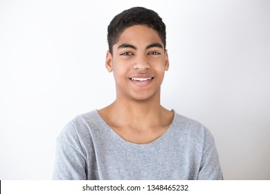 Smiling and happy black young man on white background. Portrait of a cheerful African American boy, teenager, student. - Shutterstock ID 1348465232