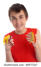 A Smiling Happy Boy Holding Handfuls Of Yummy Snakes Lollies.