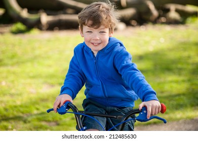 Smiling happy boy on his bicycle.