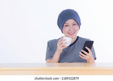 Smiling Happy Cancer Woman In Chemotherapy Period No Hair Working At Home With Technology, Laptop, Smartphone On Isolated Background