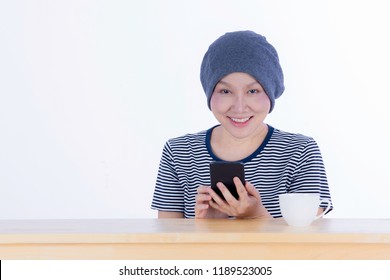 Smiling Happy Cancer Woman In Chemotherapy Period No Hair Working At Home With Technology, Laptop, Smartphone On Isolated Background