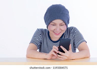 Smiling Happy Cancer Woman In Chemotherapy Period No Hair Working At Home With Technology, Laptop, Smartphone On Isolated Background