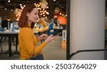 Smiling happy Caucasian woman female girl businesswoman shopper buyer customer client answering mobile phone smartphone call talking tell sales discount enjoy shopping rides escalator indoor shop mall