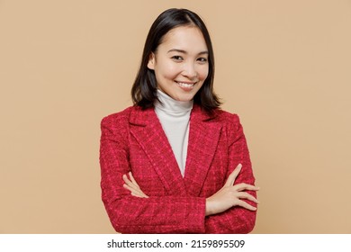 Smiling happy cheerful fun trendy woman of Asian ethnicity wear red jacket hold hands crossed folded isolated on plain pastel beige color background studio portrait. People lifestyle fashion concept - Shutterstock ID 2159895509