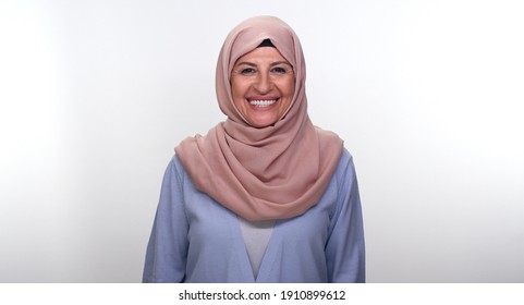 Smiling happy cheerful old woman in turban. Isolated on white background.