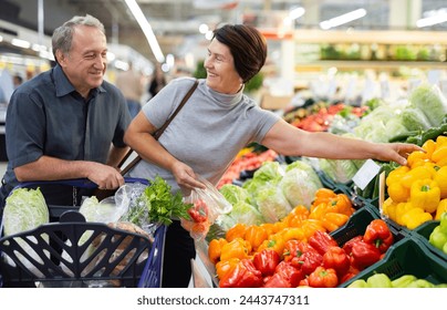 Smiling happy couple is choosing bell peppers - Powered by Shutterstock