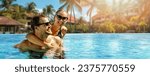 smiling happy couple having fun together in resort swimming pool. summer vacation, getaway travel. banner with copy space