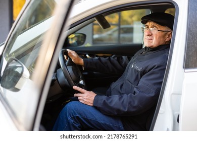 Smiling Happy Elderly Man In The New Car