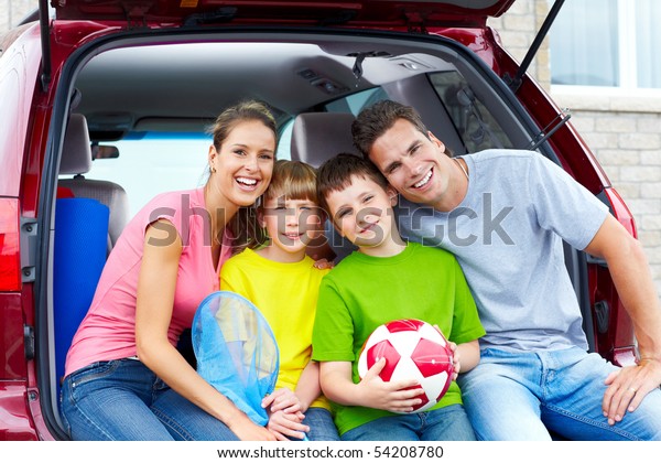 Smiling happy family and a\
family car