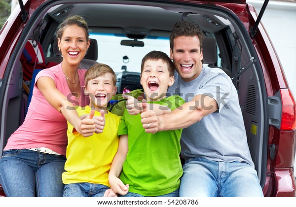 Smiling happy family and a\
family car
