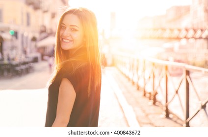 Smiling Happy Girl Looking Back At Camera