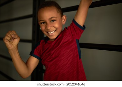 Smiling And Happy Latino American Boy Enjoy Winning, Champion In Sport. Cheerful Kid Clench Fist In Joy. Set And Achieve Goal, Sport, Competition, First Place, Winner, Train, Hobby, Healthcare Concept