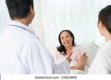 Smiling Happy Patient Looking At The Doctor On The Foreground