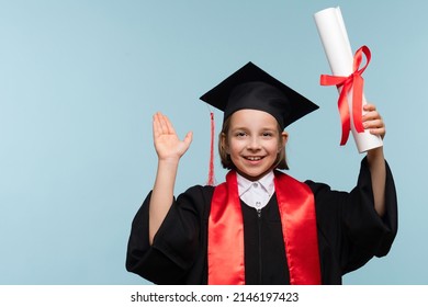 Smiling happy proud child girl in graduate suit with certificate diploma on light blue background looking at camera. Infant Prodigy Graduate Celebrating Graduation.  - Shutterstock ID 2146197423