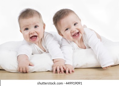 Smiling Happy Twin Baby Girls On Tummy