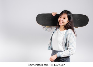 Smiling Happy Woman Holding Skateboard On Shoulder, Happy Asian Beautiful Young Female Excited Hold Hands Longboard, Studio Shot Isolated On White Background With Copy Space, Sport Extreme