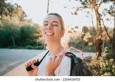 Smiling Happy Woman Holding A Trash Bag And A Garbage Collector While Cleaning The Forest.