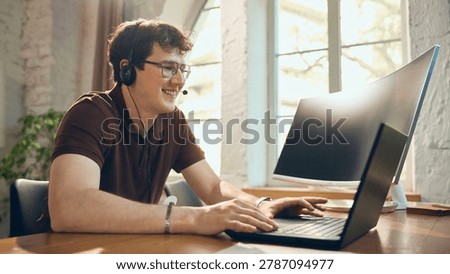 Smiling helpdesk operator consulting client from laptop. Concept of remote customer support, online consultation, service response, client care, and call center work.