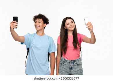 Smiling high school pupils students teenagers classmates boy girl friends social media blogger in casual with bags takes selfie photo holding mobile phone on white background. Technology concept - Powered by Shutterstock