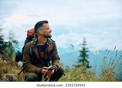 Smiling hiker enjoying the view from the mountain. Copy space. - Powered by Shutterstock