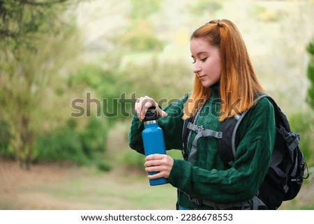 Similar – Image, Stock Photo Redheaded hiker with water bottle on nature getaway