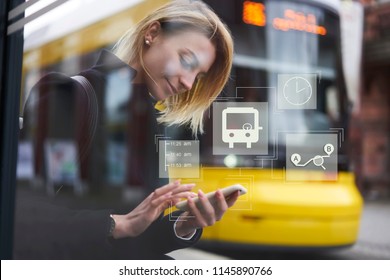 Smiling hipster girl waiting for public transport on bus stop while using application on smartphone for checking train schedule. Infographic illustration bus sign. Female chatting on cellular
