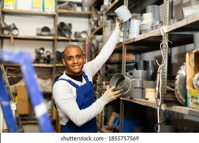 Smiling Hispanic Foreman Looking For PVC Pipes And Fittings For Plumbing Works In Building Hypermarket