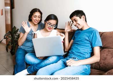 Smiling Hispanic Teen Female With Down Syndrome And Her Family Using Laptop At Home, In Disability Concept In Latin America