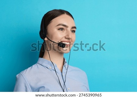 Smiling hotline operator in headset on light blue background. Space for text