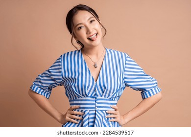 smiling humor tongue out happiness playful asia woman adult wear well dress blue stripe color pattern portrait studio shot,confident cheerful freshness smiling asian woman positive emotion look camera