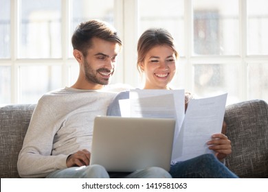 Smiling husband and wife sit on couch using laptop taking care of utility bills and house maintenance documents, happy young couple relax on sofa read paperwork, pay bank credit online via internet - Shutterstock ID 1419581063