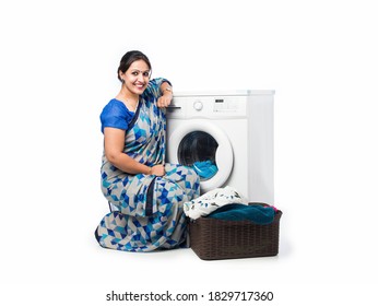 Smiling Indian Asian Housewife In Saree Standing Near Washing Machine With Basket Of Clothes