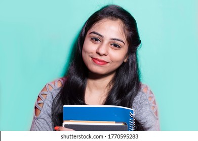 Smiling Indian Female Student Holding Books And File , College Or School Student And Education Concept.