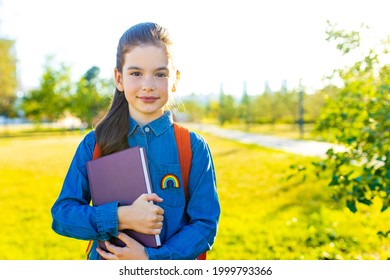 Smiling Indian Student Girl Wearing School Backpack And Blue T-shirt In Park