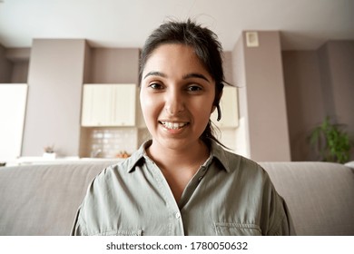 Smiling Indian Woman Online Teacher, Sales Agent, Remote Tutor Or Call Center Operator Wearing Headset Look At Webcam Zoom Conference Video Call At Home Office. Headshot Portrait. Webcamera View.