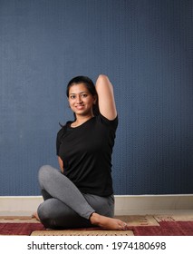 Smiling Indian Woman Practicing Yoga Gomukhasan At Home. International Yoga Day