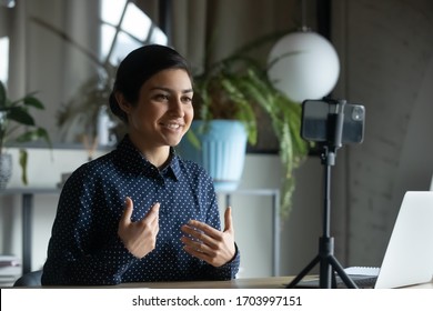 Smiling Indian Young Woman Coach Or Speaker Record Live Video Broadcast On Modern Smartphone Gadget, Positive Ethnic Millennial Girl Shoot Webinar Or Online Training Course On Cellphone Device