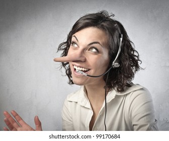 Smiling insincere receptionist with long nose talking on the telephone - Shutterstock ID 99170684