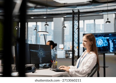 Smiling junior IT specialist writing code, developing machine learning APIs. Upbeat young female technician working in office, troubleshooting software errors using artificial intelligence tech