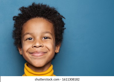 Smiling Kid Boy Portrait. Little African American Child Boy On Blue Background